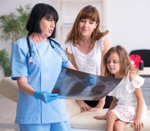 Mom and kid with doctor radiography