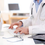 healthcare professional on computer