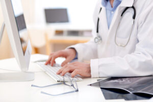healthcare professional on computer
